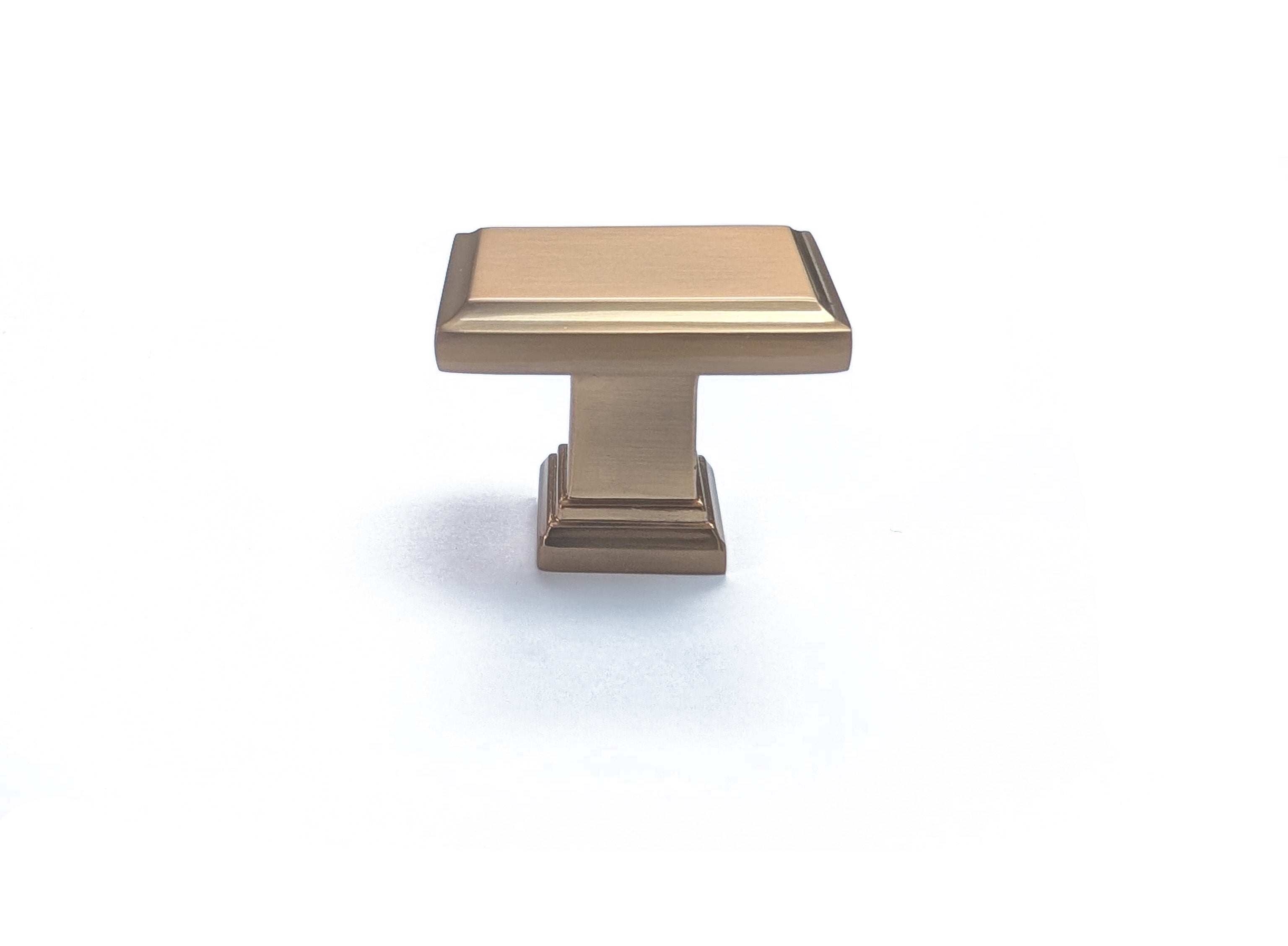 A gold colored angular square rectangular knob from the Column Collection, intended for use on a kitchen or bath cabinet or furniture piece. Champagne Gold Bronze sleek modern contemporary decorative HardwareDirect