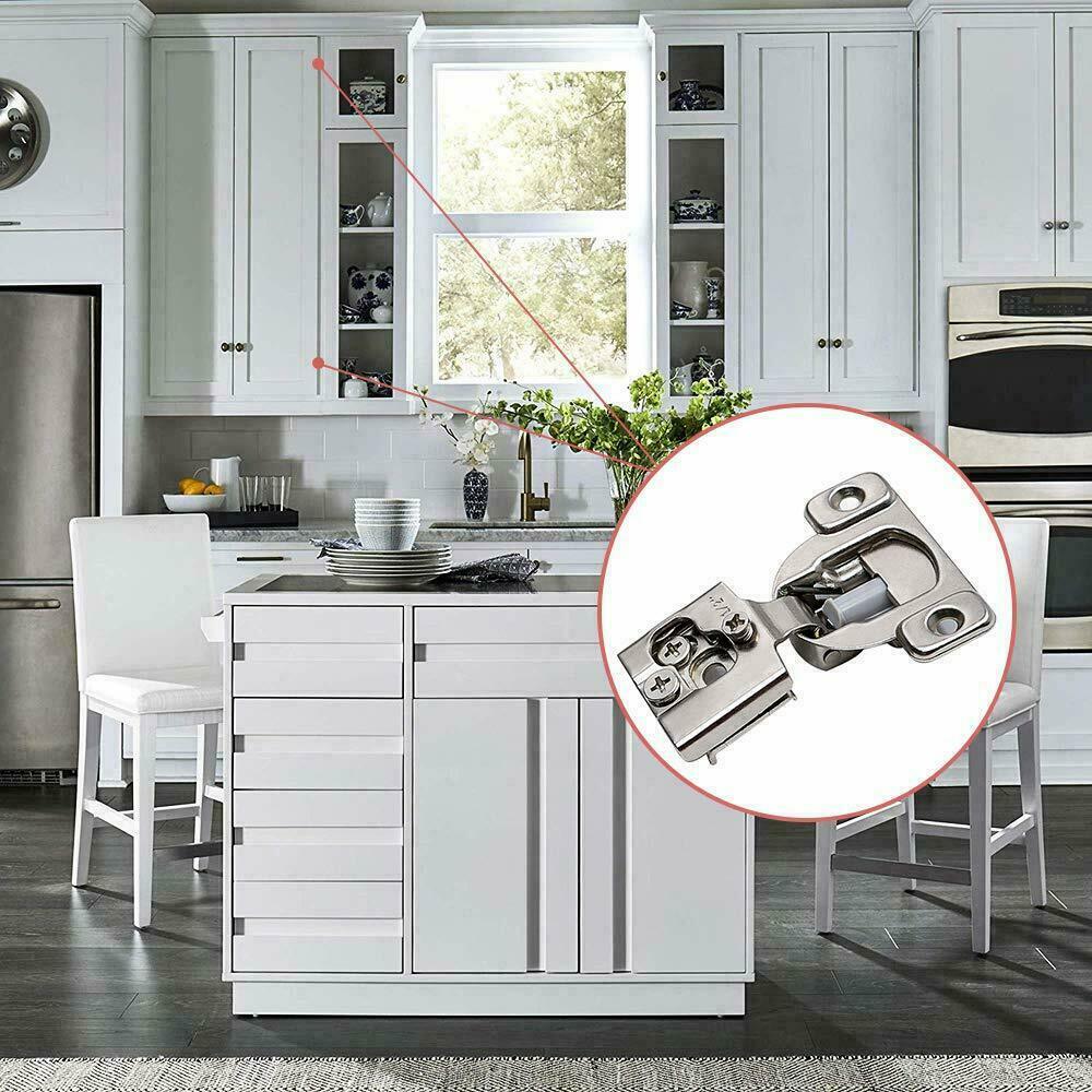 A silver metal soft-closing compact hinge shown inside a kitchen Brushed Nickel 1/2 inch HardwareDirect
