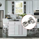 A silver metal soft-closing compact hinge shown inside a kitchen Brushed Nickel 1/2 inch HardwareDirect
